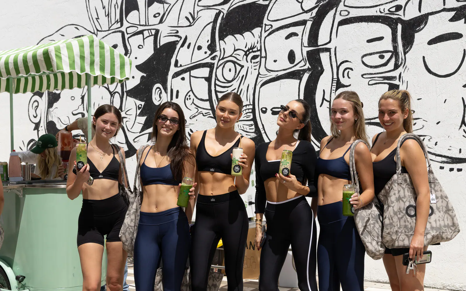 A group enjoying The Matcha Bike at an Alo Wellness Club activation